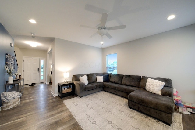 living room featuring ceiling fan and wood-type flooring