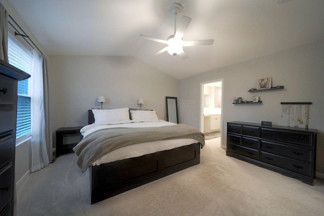 carpeted bedroom featuring ensuite bath, ceiling fan, and lofted ceiling