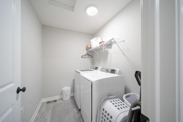 clothes washing area with washer and dryer