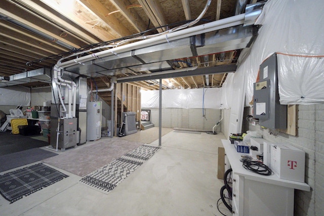 basement with electric water heater and heating unit