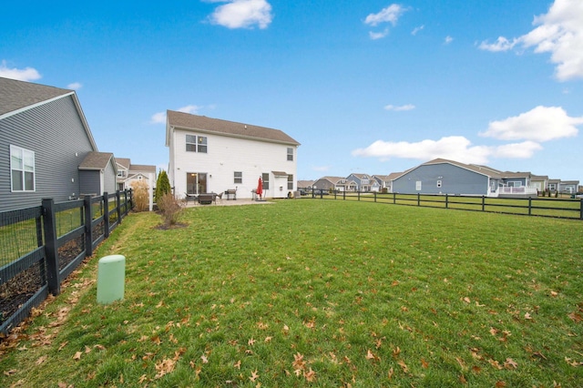 rear view of property featuring a lawn and a patio