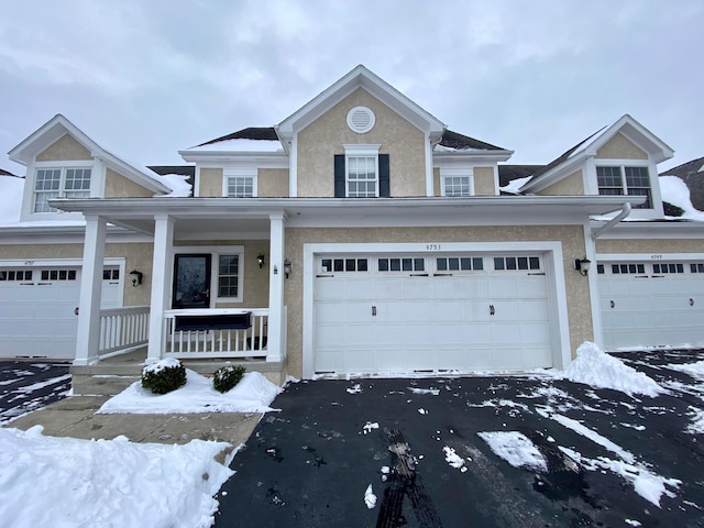 view of front of house featuring a porch and a garage