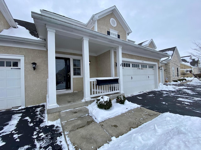 view of front facade featuring a garage and covered porch