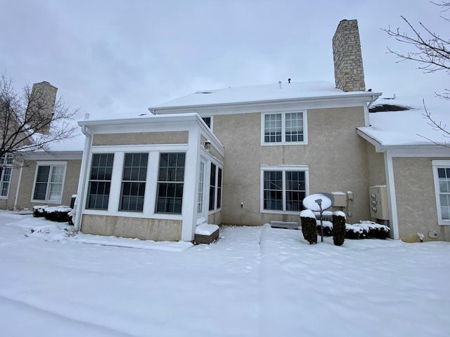 view of snow covered back of property