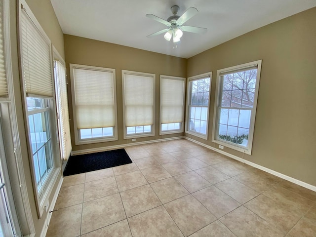 unfurnished room featuring ceiling fan and light tile patterned flooring