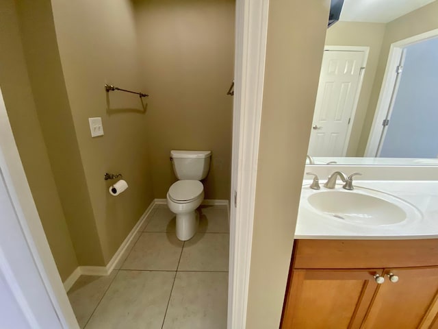 bathroom featuring tile patterned floors, vanity, and toilet