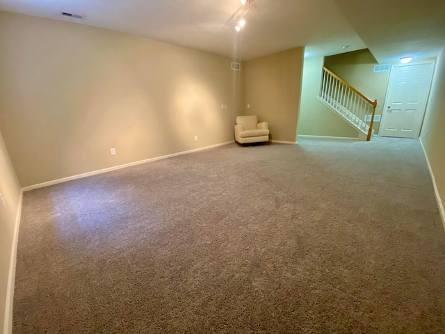 spare room with carpet floors and track lighting