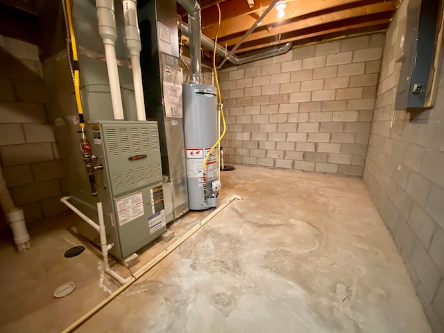 utility room with electric panel and water heater