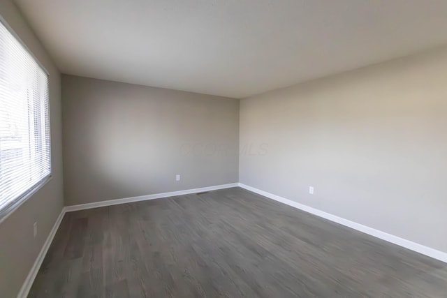 unfurnished room with dark hardwood / wood-style floors