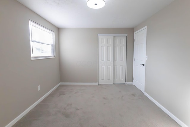 unfurnished bedroom featuring light colored carpet