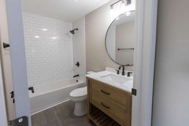 full bathroom featuring vanity, toilet, wood-type flooring, and tiled shower / bath combo