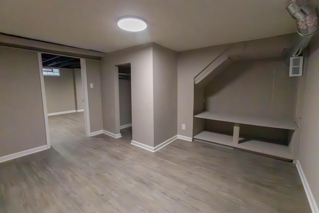 basement with hardwood / wood-style flooring