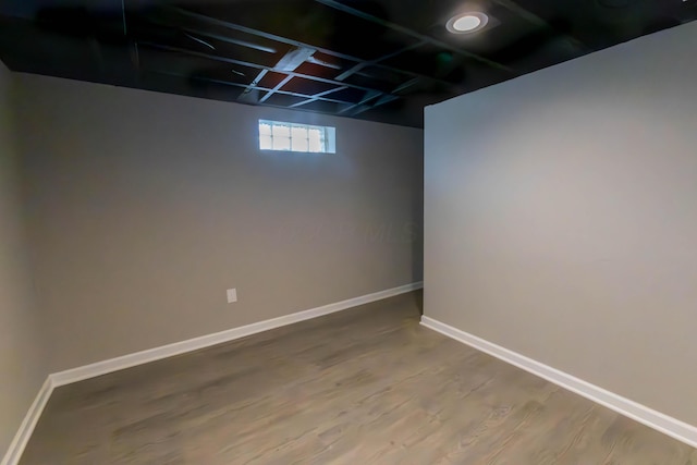 basement with hardwood / wood-style floors