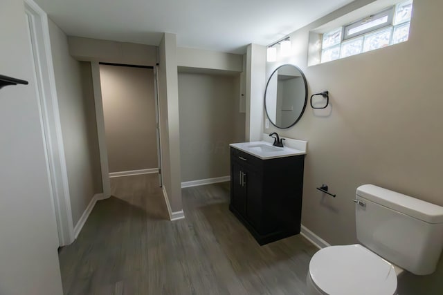 bathroom with hardwood / wood-style floors, vanity, and toilet