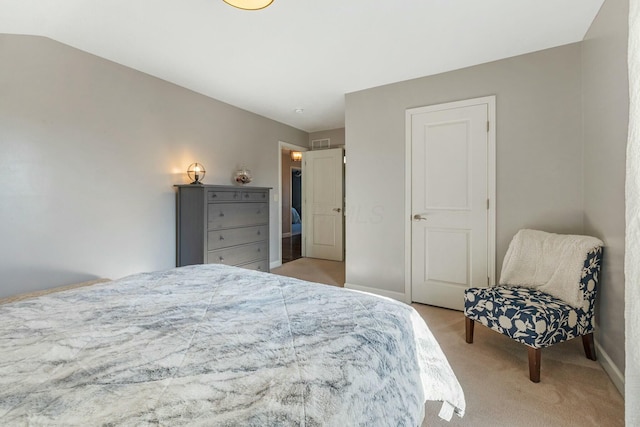 carpeted bedroom with lofted ceiling