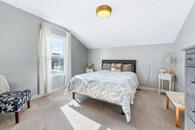 carpeted bedroom with lofted ceiling