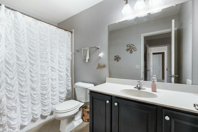 bathroom featuring vanity, tile patterned flooring, and toilet