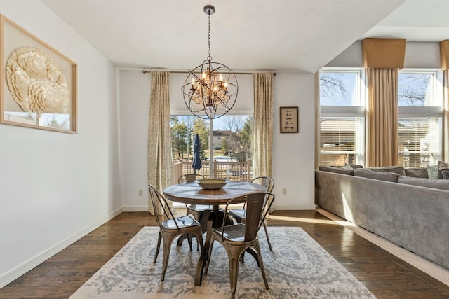 dining area with a notable chandelier and dark hardwood / wood-style floors