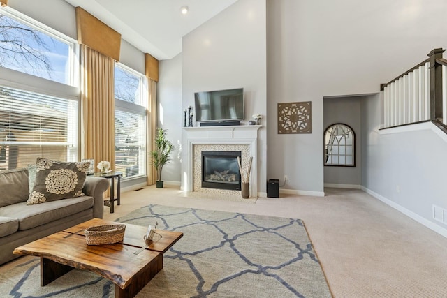 carpeted living room with high vaulted ceiling