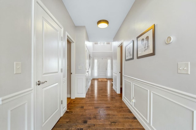 hallway with dark hardwood / wood-style flooring