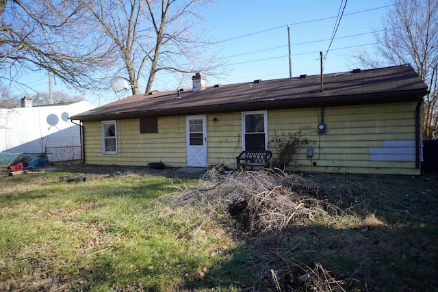 back of house with a lawn