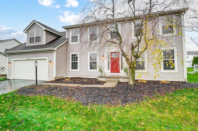 view of front of property with a garage and a front lawn