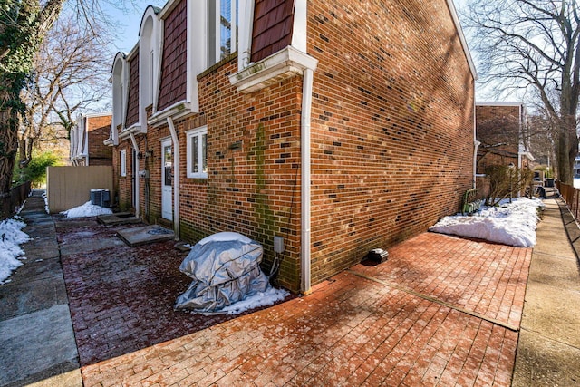 view of side of property with cooling unit and a patio