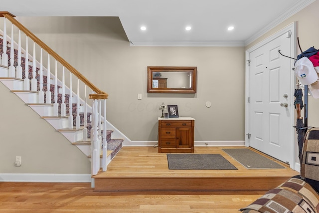 entrance foyer featuring wood-type flooring and ornamental molding