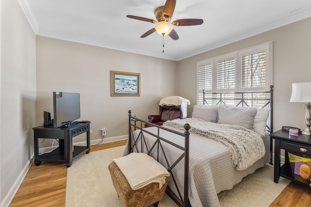 bedroom featuring light wood-type flooring, ceiling fan, and crown molding