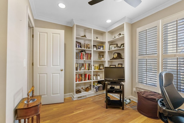 office space featuring ceiling fan, crown molding, built in features, and light wood-type flooring