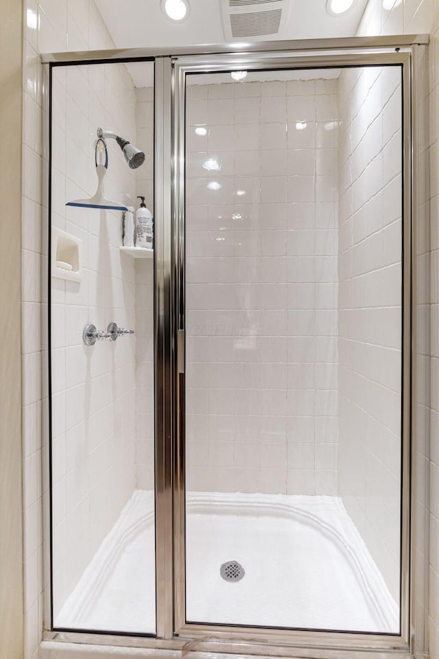 bathroom with a shower with door