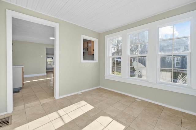 tiled spare room with a wealth of natural light