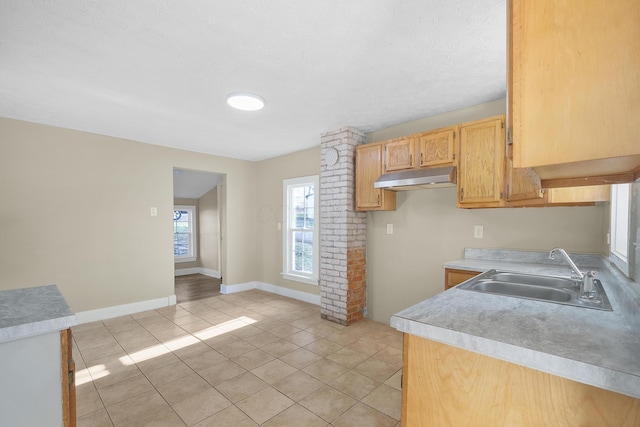 kitchen featuring sink and light tile patterned floors