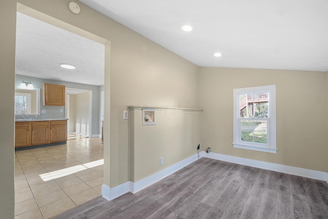 washroom featuring light hardwood / wood-style floors, gas dryer hookup, sink, and hookup for a washing machine