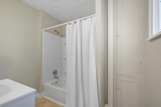 bathroom featuring tile patterned floors, sink, a textured ceiling, and shower / tub combo