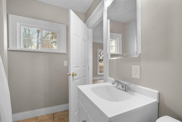 bathroom with tile patterned flooring and vanity