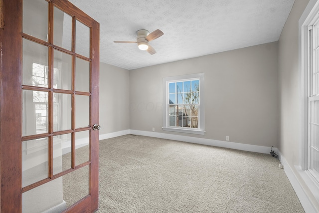 carpeted empty room with a textured ceiling and ceiling fan