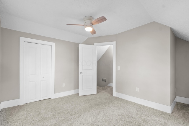 bonus room with ceiling fan, light carpet, and vaulted ceiling