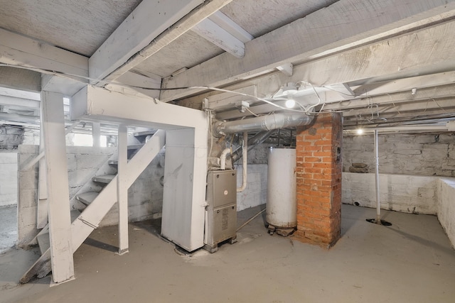 basement featuring gas water heater and heating unit