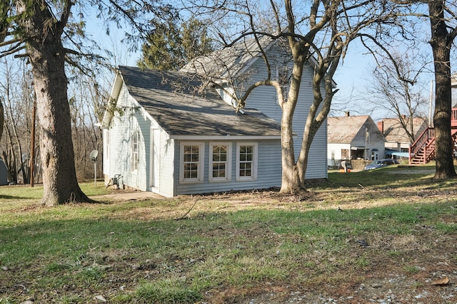 view of side of property with a yard