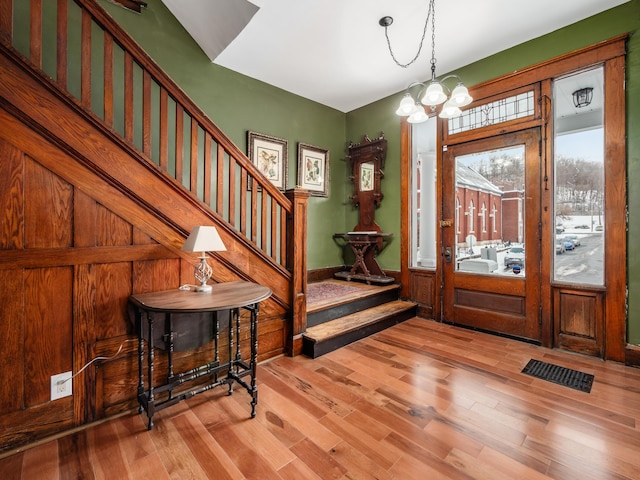 entrance foyer with light wood-type flooring and a notable chandelier