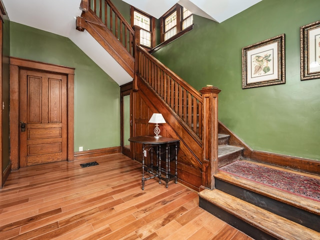 staircase with hardwood / wood-style flooring