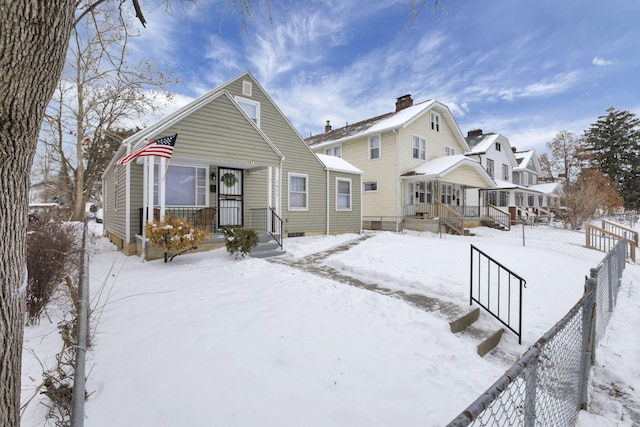 view of snow covered rear of property