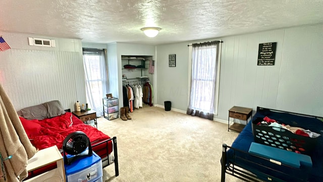 sitting room featuring carpet and a textured ceiling