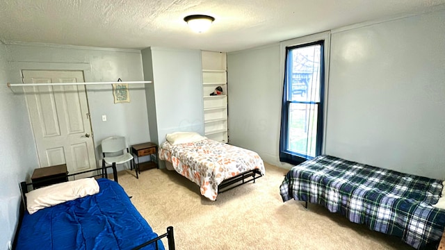 carpeted bedroom featuring a textured ceiling