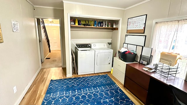 washroom featuring wood-type flooring, separate washer and dryer, and crown molding