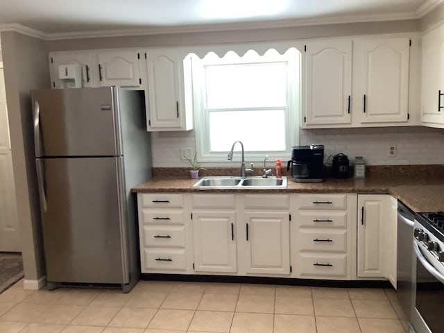 kitchen with white cabinets, sink, stainless steel appliances, and tasteful backsplash