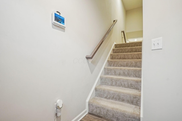 stairs with wood-type flooring