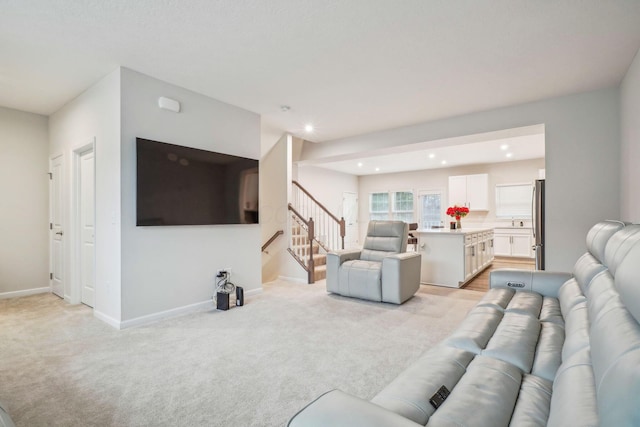 living room featuring light carpet and sink