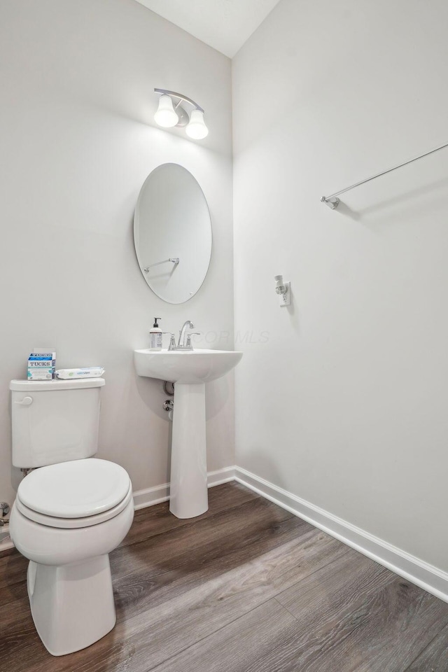 bathroom featuring hardwood / wood-style floors and toilet